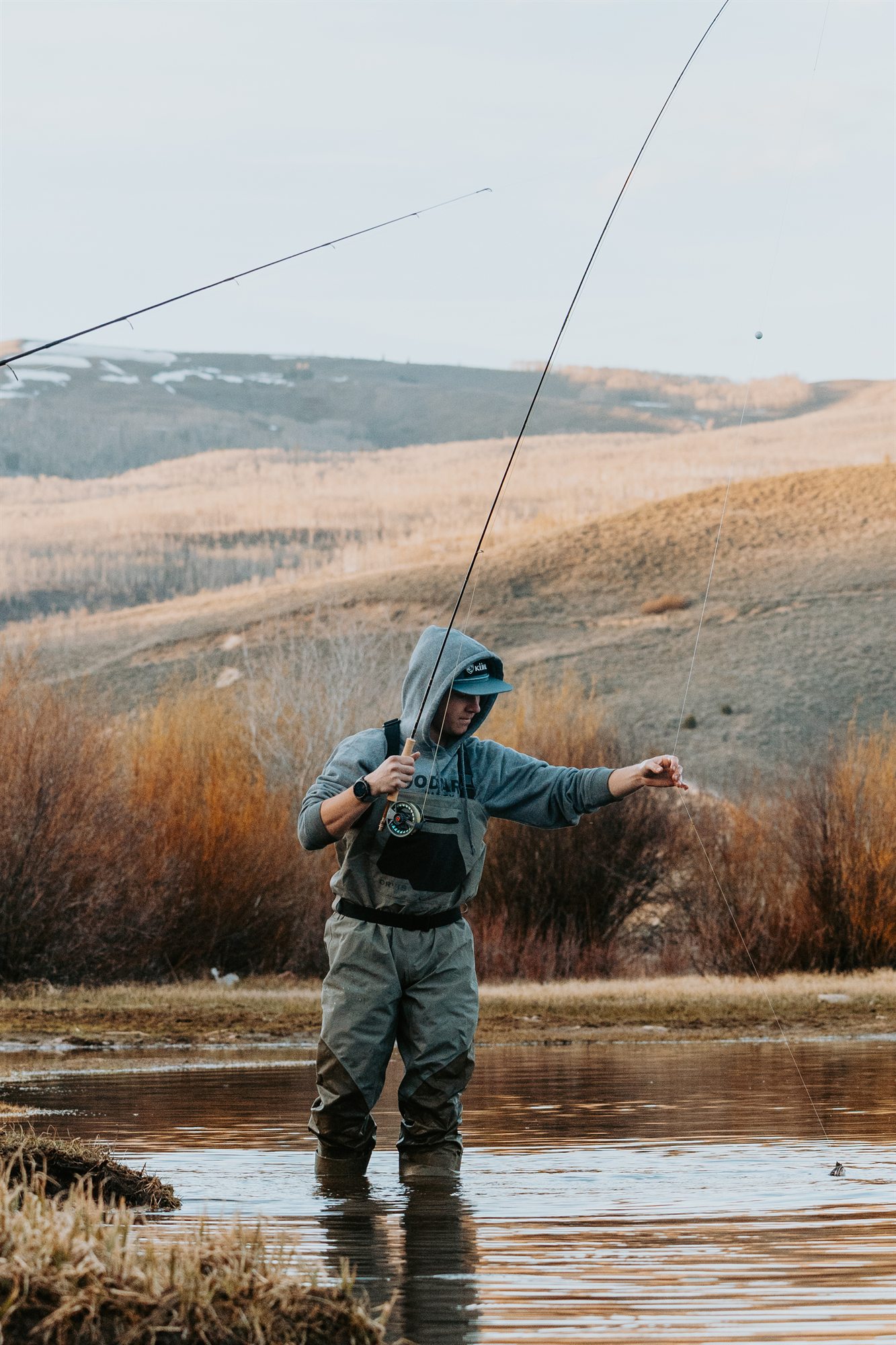 Fly fisherman photographed in a natural outdoor setting